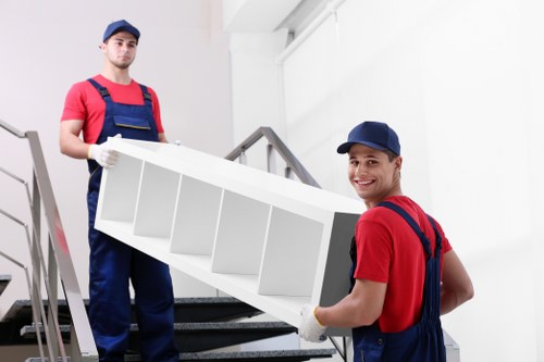 Professional house movers handling furniture in Wimbledon